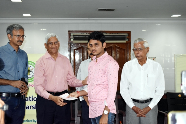 Distributing Scholarship Cheque hand on Dr. Rao Chalasani.