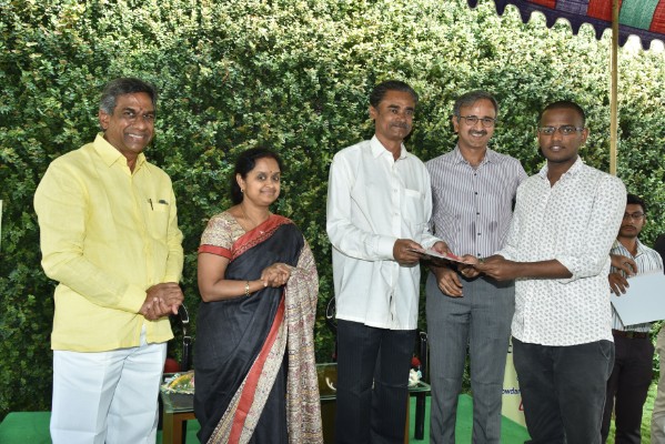 Distributed scholarship cheque on hand Director of Nandigam Sudhakar